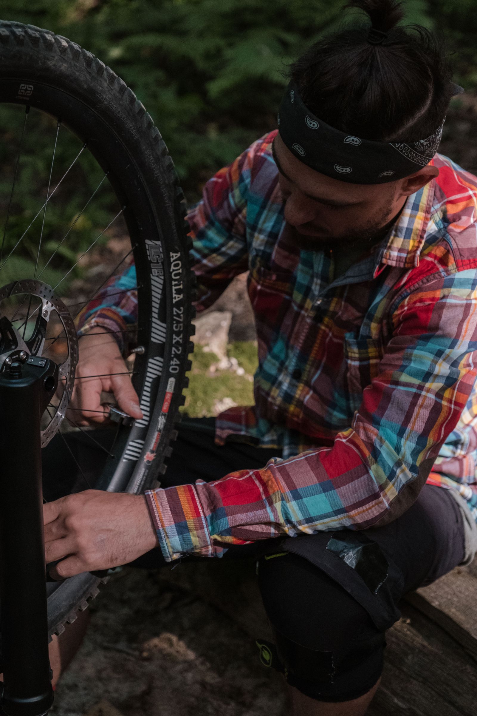 Working on a bicycle tire and wheel during a repair.